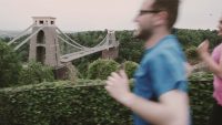 Clifton Suspension Bridge in the background with blurred joggers in the foreground