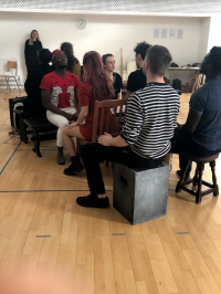 Students sat down in rehearsal
