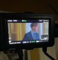 Image of a man in a suit and tie on a camera viewfinder
