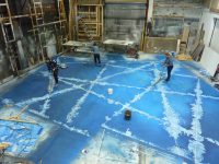 Scenic Artists working on floor for The Snow Queen