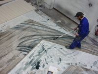 Scenic Art student painting the floor for the Wizard of Oz