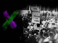 Black and white photo of suffragettes marching and carrying a banner