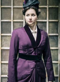 Actress wearing purple Edwardian jacket and skirt